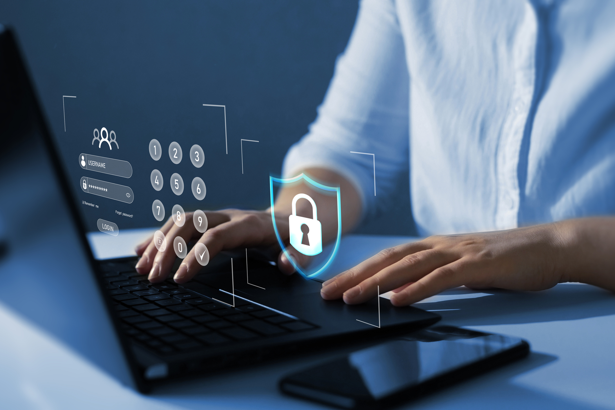 Person typing on laptop with security icons.