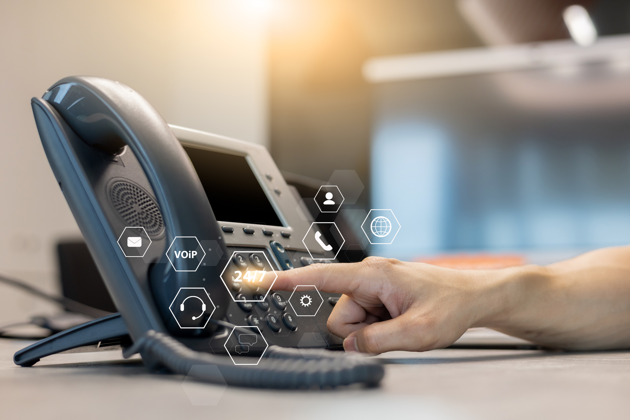 Finger pressing button on office phone.