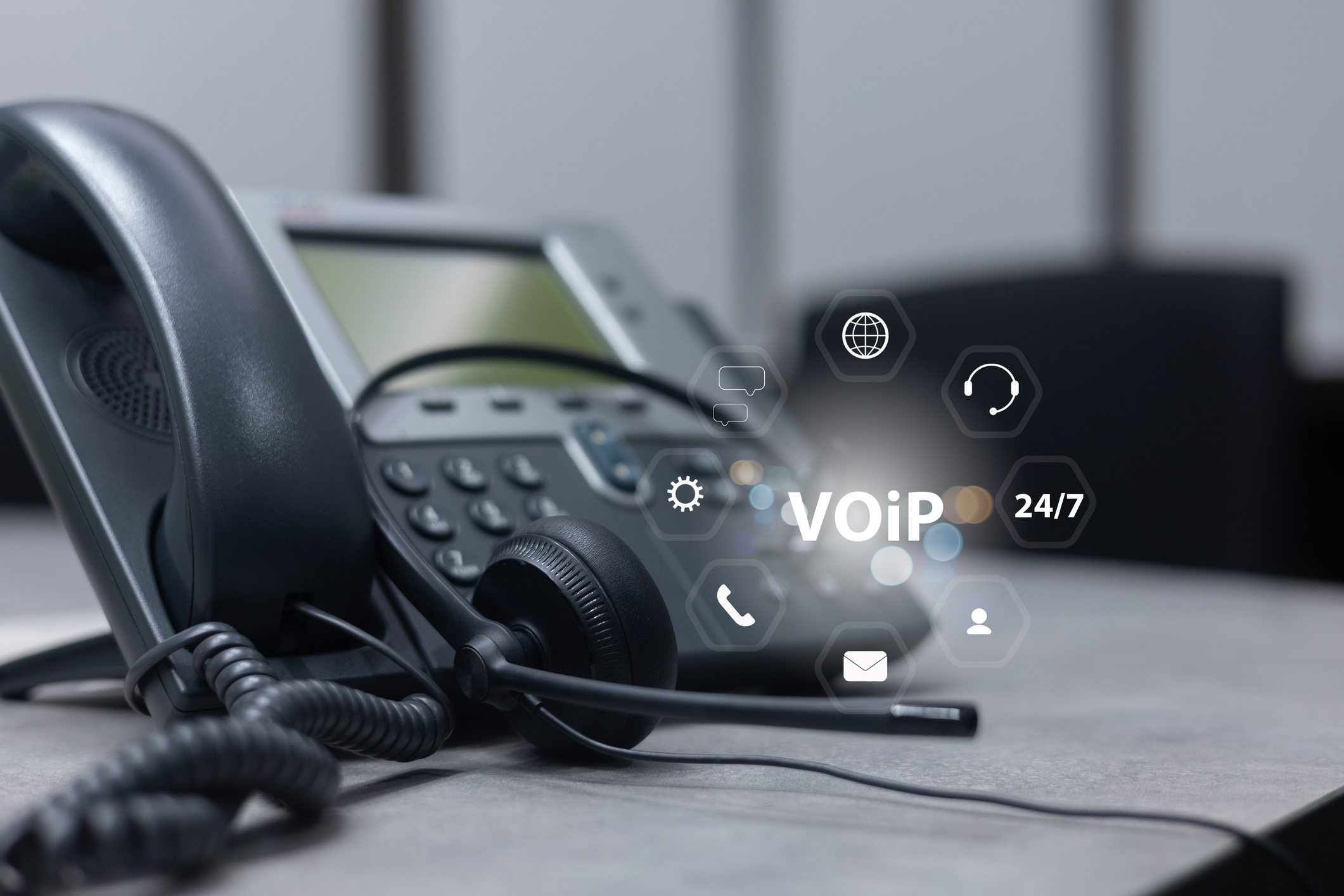 VoIP phone with digital interface icons.