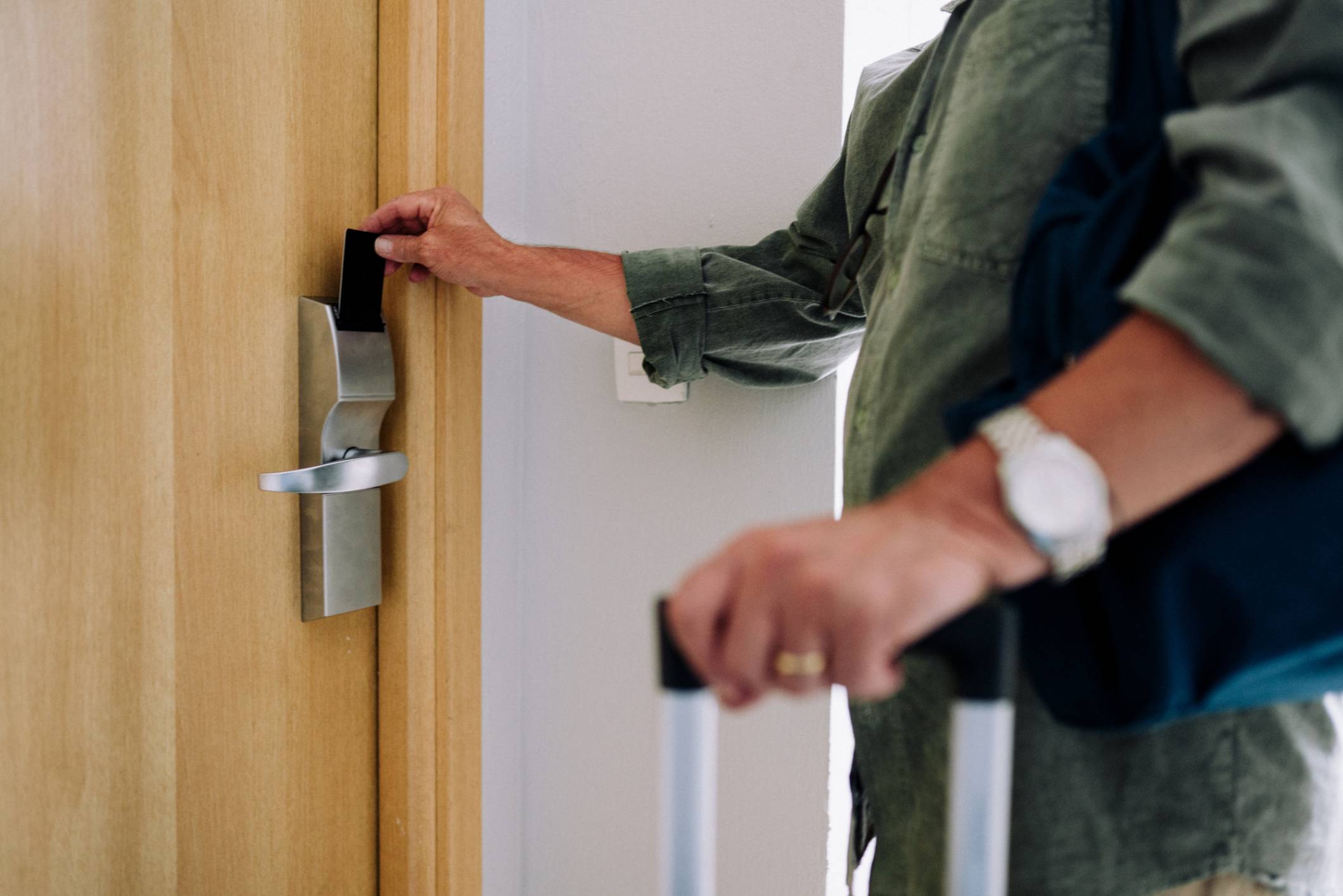 Guest using keycard to open hotel door